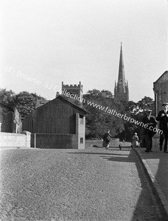 CATHEDRAL WITH STREET AND HOUSES IN FOREGROUND